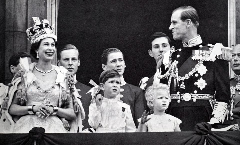 Buckingham Palace balcony, Coronation day 1953. The Queen and the Duke exchange smiles while Prince Charles and Princess Anne are absorbed with the planes roaring overhead.