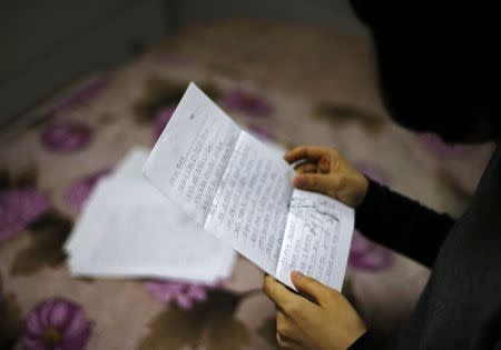 The daughter of a convicted crew member of the sunken ferry Sewol reads a letter from her father, at her home in Jindo November 18, 2014. REUTERS/Kim Hong-Ji