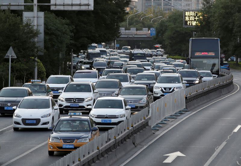 FILE PHOTO: Cars drive on the road during the evening rush hour in Beijing