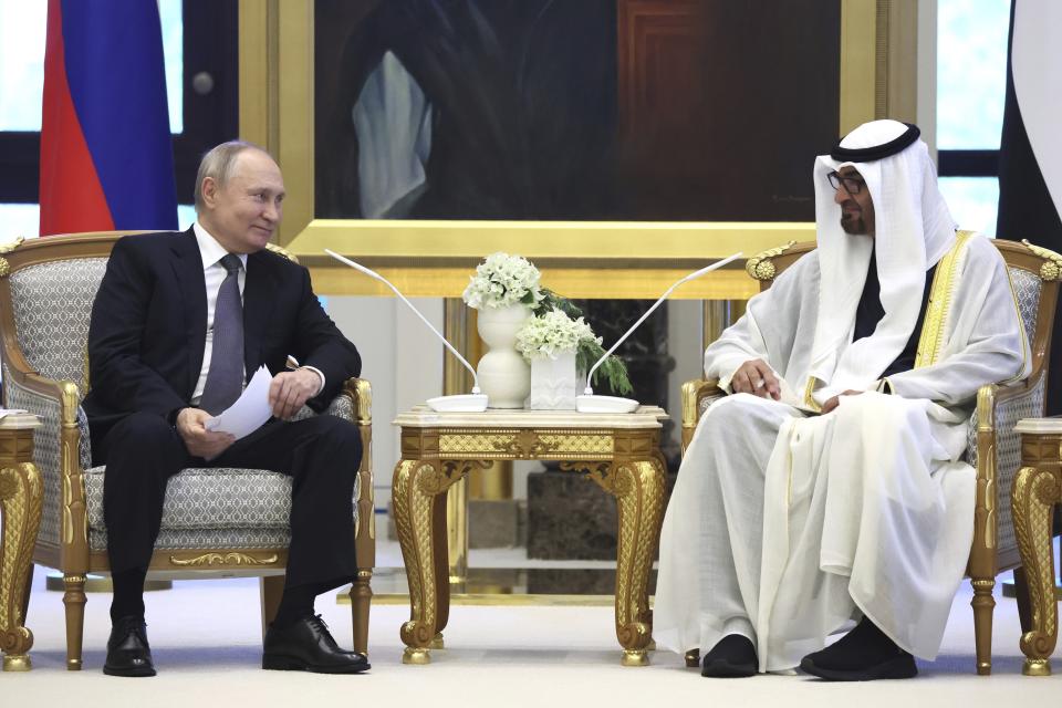 Emirati President Sheikh Mohammed bin Zayed Al Nahyan, right, and Russian President Vladimir Putin talk to each other at Qasr Al Watan, Abu Dhabi, United Arab Emirates, Wednesday, Dec. 6, 2023. (Sergei Savostyanov, Sputnik, Kremlin Pool Photo via AP)