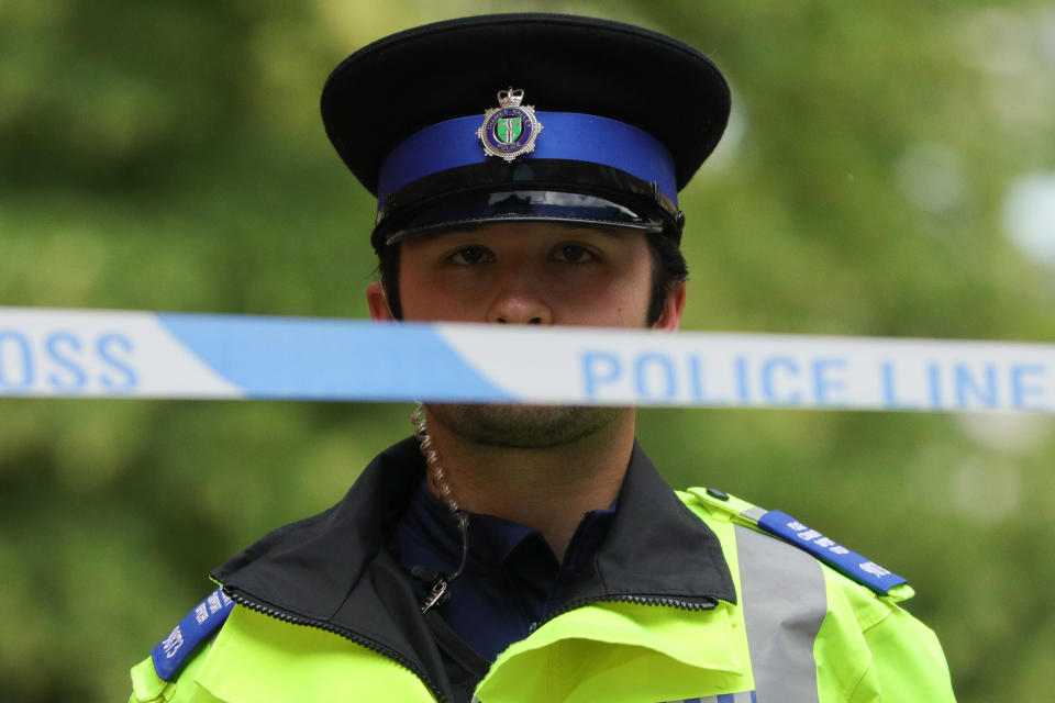 READING , June 21, 2020  -- A police officer stands behind a police cordon at an entrance to Forbury Gardens where stabbings took place in Reading, Britain, on June 21, 2020. Britain's counter-terrorism police said Sunday that the stabbing incident taking place in southern England's town of Reading on Saturday night "has now been declared a terrorist incident."(Photo by Tim Ireland/Xinhua via Getty) (Xinhua/ via Getty Images)