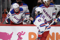 New York Rangers center Mika Zibanejad (93) celebrates his empty net goal with defenseman Brendan Smith (42) during the third period of an NHL hockey game against the Washington Capitals, Saturday, Feb. 20, 2021, in Washington. The Rangers won 4-1. (AP Photo/Nick Wass)