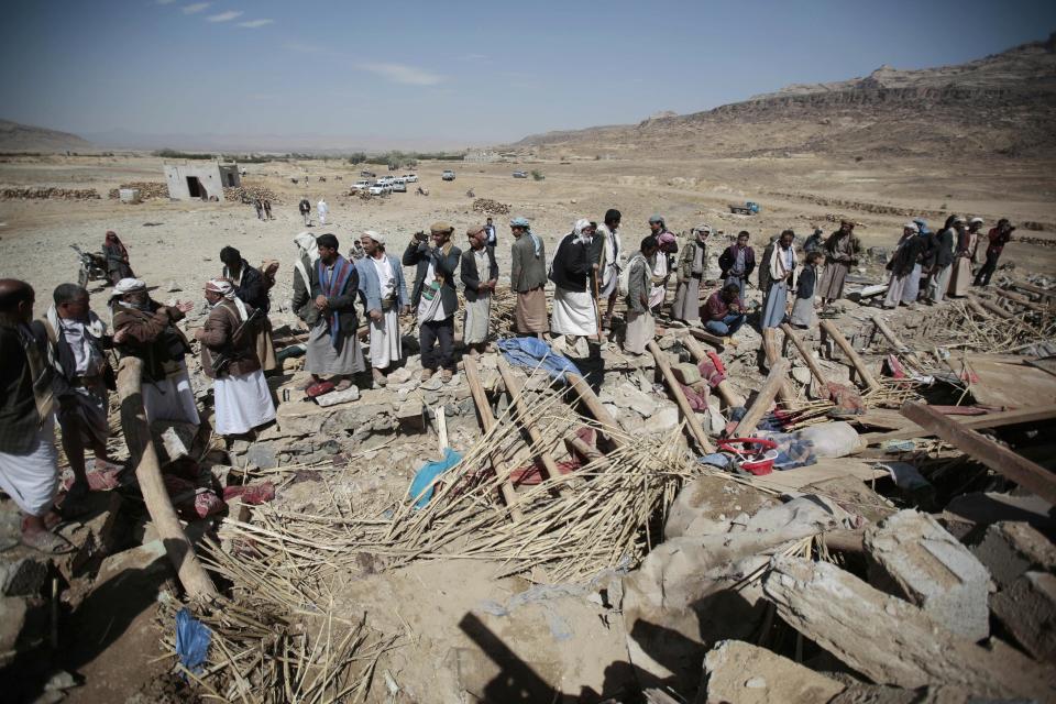 People stand on the rubble of a house destroyed by a Saudi-led airstrike in the outskirts of Sanaa, Yemen, Thursday, Feb. 16, 2017. At least one Saudi-led airstrike near Yemen's rebel-held capital killed at least five people on Wednesday, the country's Houthi rebels and medical officials said. (AP Photo/Hani Mohammed)