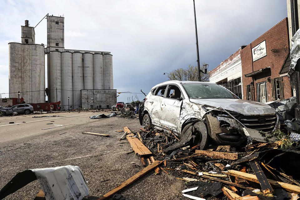 A vehicle and buildings are damaged in Perryton, Texas, after a tornado struck Thursday, June 15, 2023. (AP Photo/David Erickson)