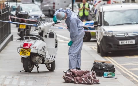 Forensic investigators analysing the scene following the robbery - Credit: Amer Ghazzal / Alamy Live News