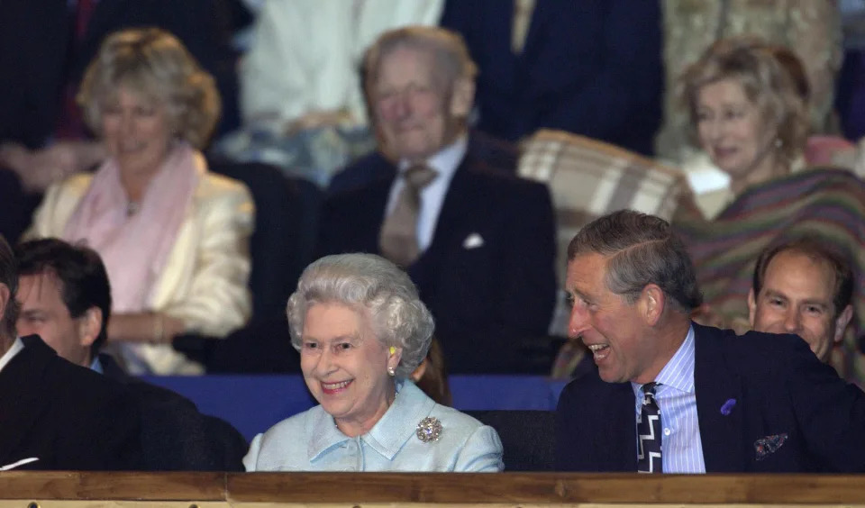 LONDON - JUNE 3: (FILE PHOTO) Camilla Parker-Bowles can be seen sitting behind the Queen and Prince Charles at the start of the Golden Jubilee pop concert in the gardens of Buckingham Palace on June 3, 2002 in London, England.  Clarence House has confirmed today that Charles and partner Camilla Parker-Bowles will marry, at a date expected to be circa April 6, 2005.  (Photo by Tim Graham Photo Library via Getty Images)