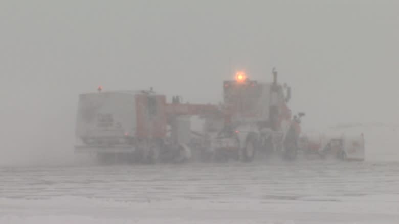 Crews clear runways blanketed with snow Friday at the Halifax Stanfield International Airport.