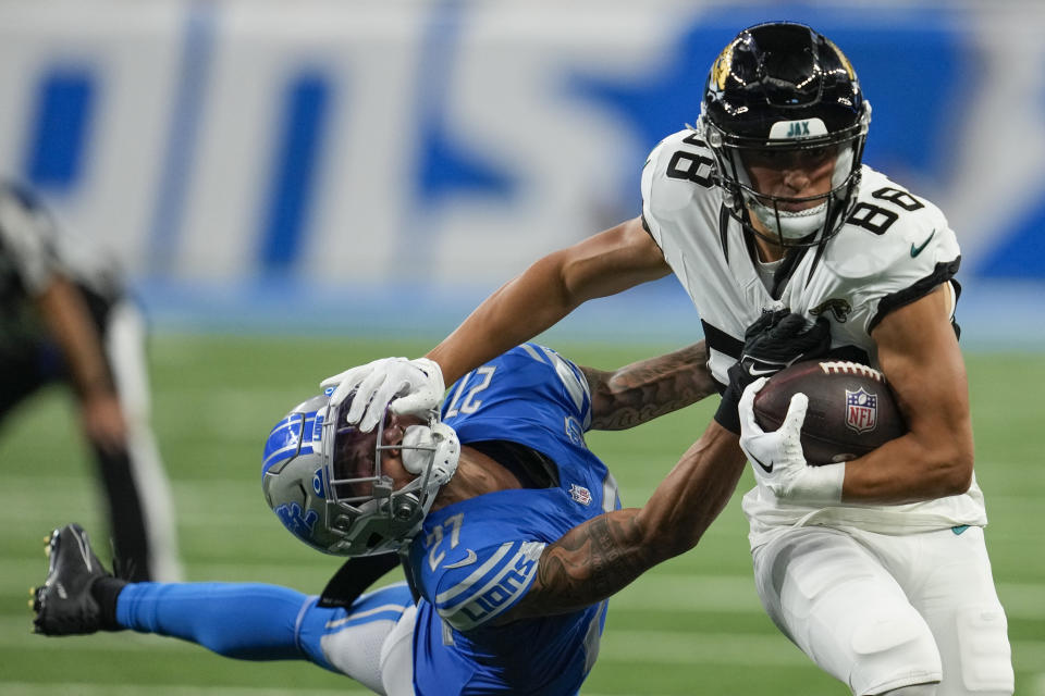 Jacksonville Jaguars wide receiver Oliver Martin (88) tries to fend off a tackle from Detroit Lions cornerback Chase Lucas (27) during the second half of a preseason NFL football game, Saturday, Aug. 19, 2023, in Detroit. (AP Photo/Paul Sancya)