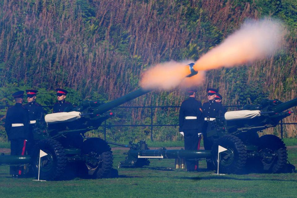 Reservists from 104 Regiment Royal Artillery fire a royal gun salute from Cardiff Castle (PA)