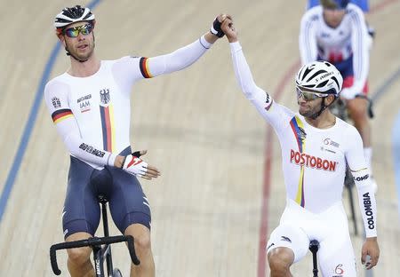 UCI World Track Cycling Championships - London, Britain - 5/3/2016 - Fernando Gaviria of Colombia (R) is congratulated by Roger Kluge of Germany after winning the men's omnium. REUTERS/Andrew Winning