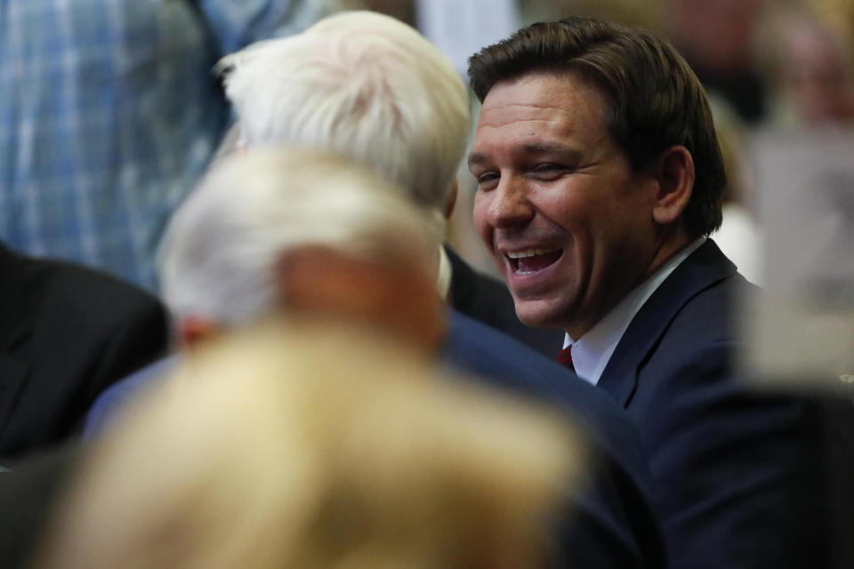 Ron DeSantis laughs during a dinner in Hillsdale, Mich.