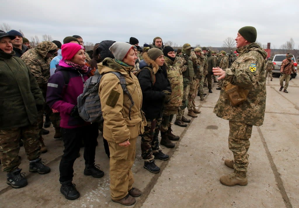 Reservists of the Ukrainian Territorial Defence Forces listen to instructions during military exercises at a training ground outside Kharkiv (Reuters)