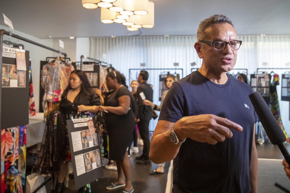 Designer Naeem Khan gives an interview backstage before his collection is modeled during Fashion Week, Tuesday, Sept. 10, 2019, in New York. (AP Photo/Mary Altaffer)