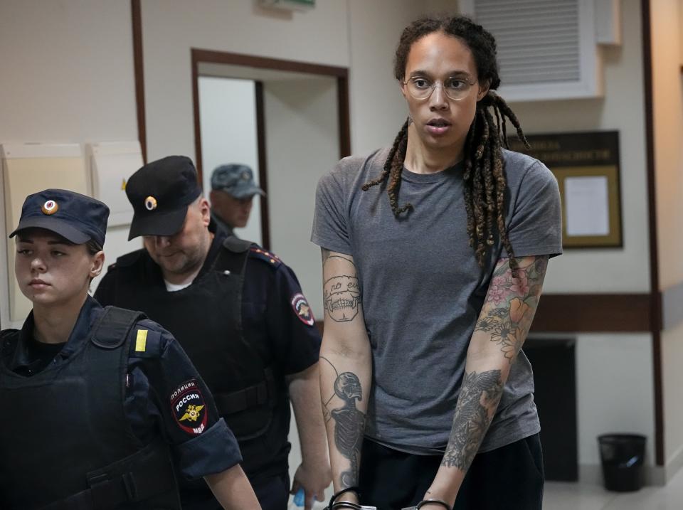 FILE - WNBA star and two-time Olympic gold medalist Brittney Griner is escorted from a courtroom after a hearing in Khimki just outside Moscow, Russia, on Aug. 4, 2022. WNBA star Brittney Griner, is the focus of efforts by the United States to arrange a prisoner swap with Russia. The Associated Press and other news organizations have reported that Washington has offered to exchange Griner and Whelan for Viktor Bout, a Russian arms dealer who is serving a 25-year sentence in the U.S. and once earned the nickname the "merchant of death."(AP Photo/Alexander Zemlianichenko, File)