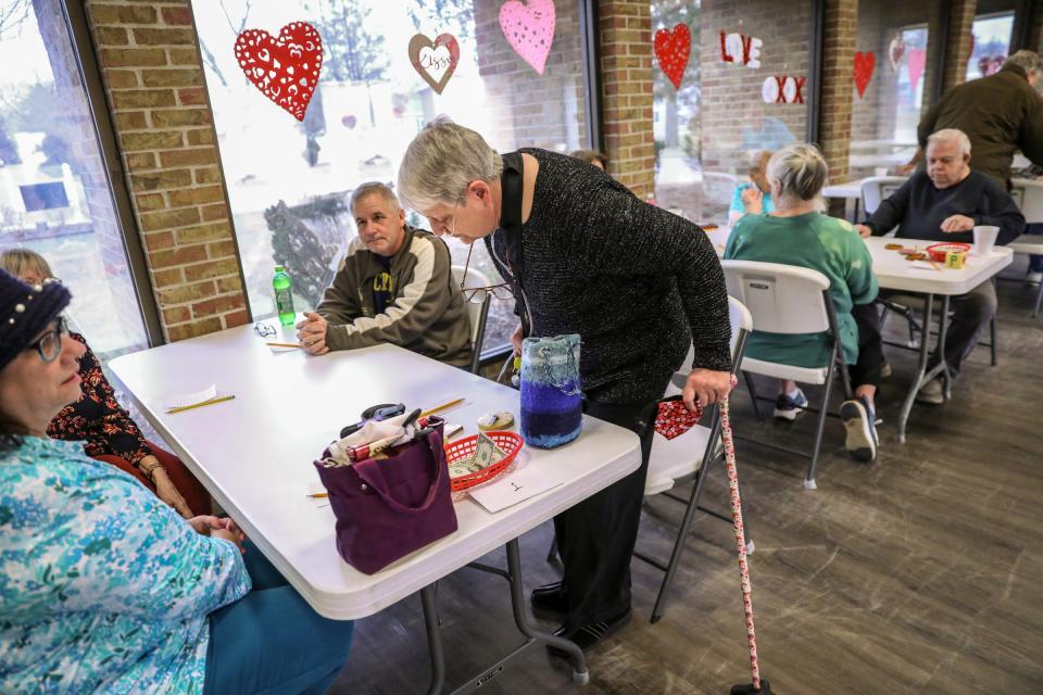 Carla Kinsey sits down to play euchre with residents at the Avon on the Lake mobile home community in Rochester Hills on Wednesday, Feb. 28, 2024. Kinsey says she is worried about becoming homeless with the increased costs of living at Avon.