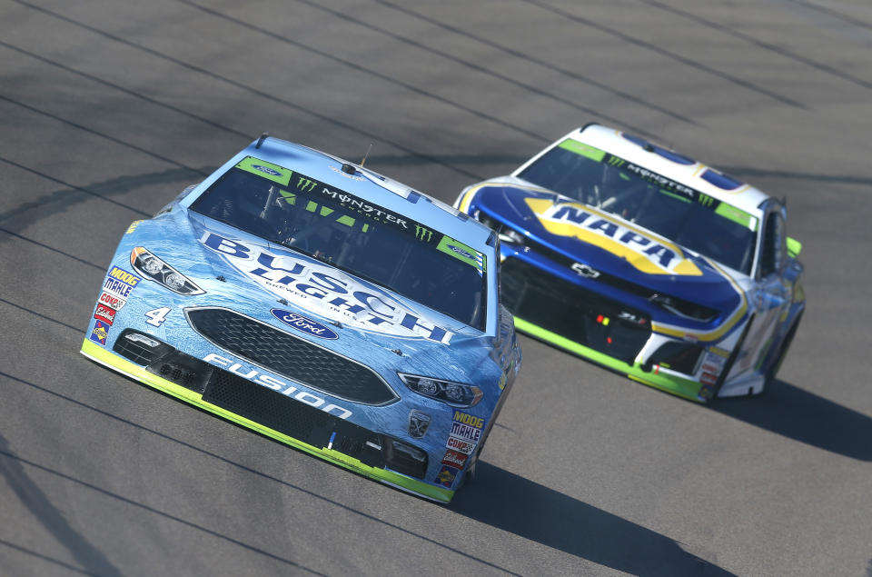 Kevin Harvick (4) leads Chase Elliott on lap four during a NASCAR Cup Series auto race on Sunday, Nov. 11, 2018, in Avondale, Ariz. (AP Photo/Rick Scuteri)
