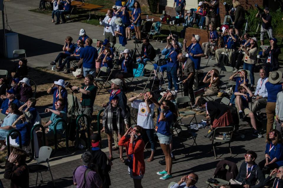 A crowd looks up at the time of the solar eclipse in Salem, Ore., on Aug. 21, 2017.