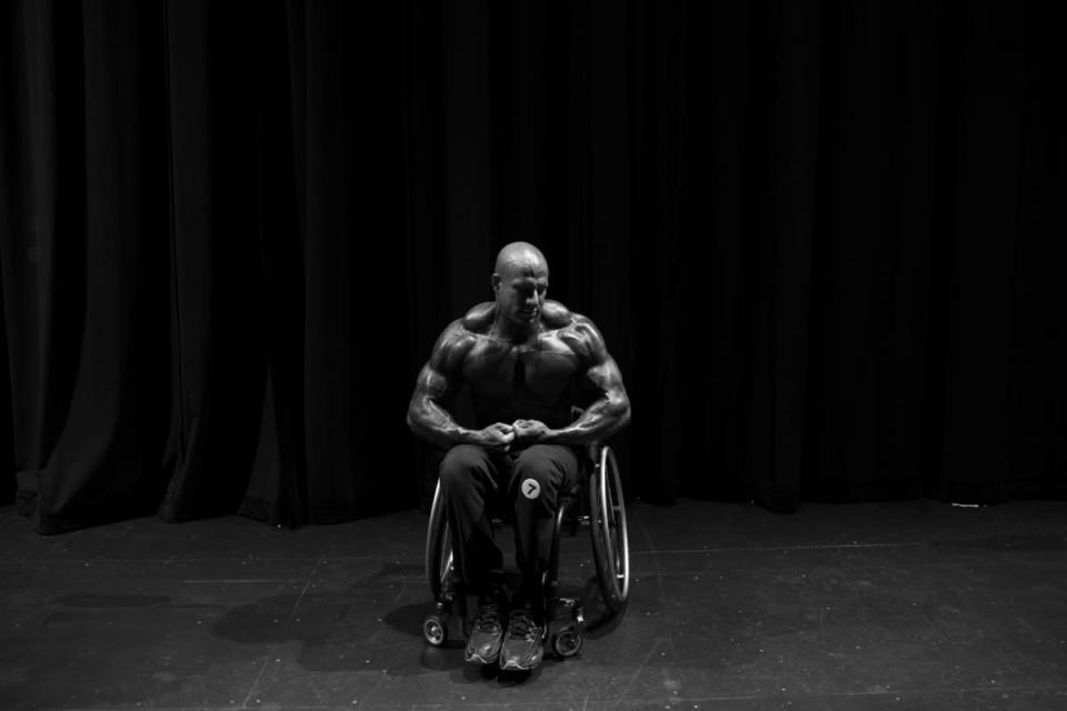 Nick Scott practices his poses backstage at the first ever Wheelchair Pro Show in Houston. When he was 16, Scott was in a near-fatal car accident. He was left paralyzed from the waist down. Nonetheless, now 30, Scott is also known in certain circles—namely, the wheelchair bodybuilding world, a universe in which his is perhaps the most recognizable face—as “The Beast.” The Beast isn’t sure of his bench press limit, only because he hasn’t yet stopped reaching for more weight. ”If you want something bad enough, nothing's gonna stop you from not getting it,” he has said. (Photo by Lauren Fleishman for TIME) <br> <br> <a href="http://lightbox.time.com/2012/10/15/wheelchair-bodybuilders/#1" rel="nofollow noopener" target="_blank" data-ylk="slk:Click here to see the full collection and story at TIME.com;elm:context_link;itc:0;sec:content-canvas" class="link ">Click here to see the full collection and story at TIME.com</a>