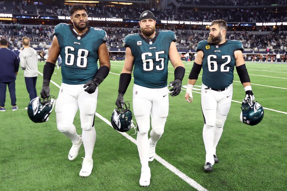 Philadelphia Eagles offensive tackle Jordan Mailata (68) and offensive tackle Lane Johnson (65) and center Jason Kelce (62) walk off the field after the game against the Dallas Cowboys at AT&T Stadium.