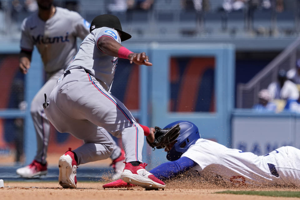 Los Angeles Dodgers' Mookie Betts, right, is tagged out by Miami Marlins third base Vidal Bruján while attempting to steal second during the eighth inning of a baseball game Wednesday, May 8, 2024, in Los Angeles. (AP Photo/Mark J. Terrill)