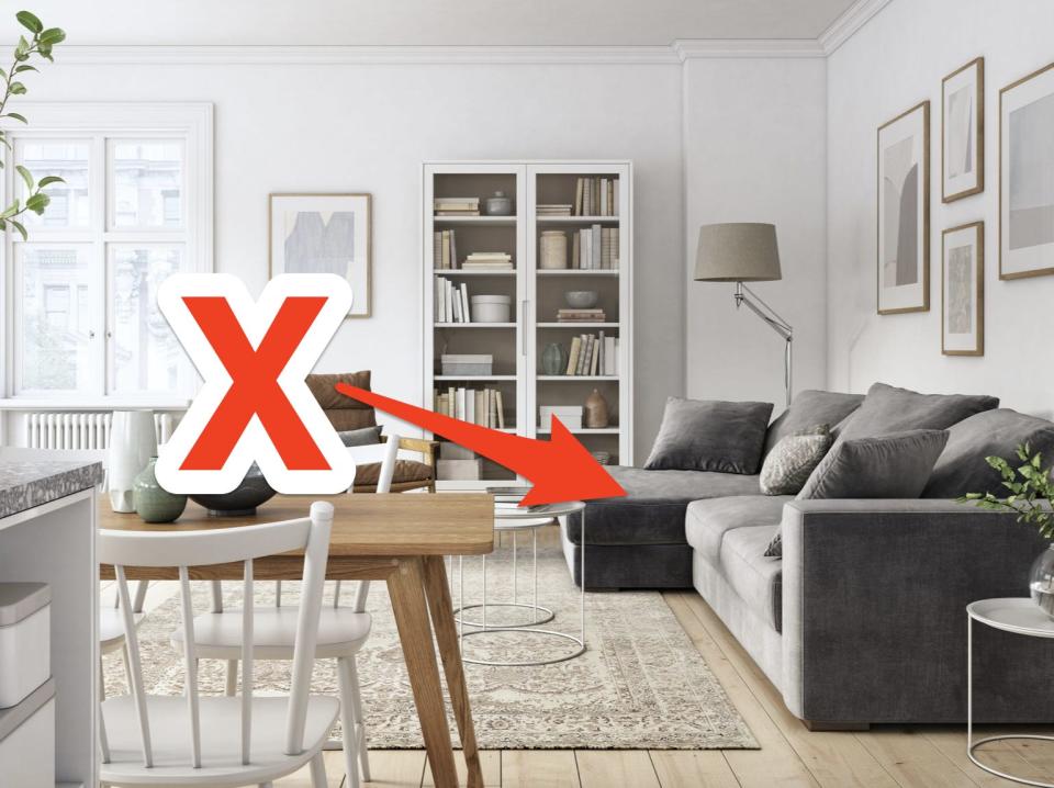 red x and arrow pointing at a gray sectional couch in a neutral living room