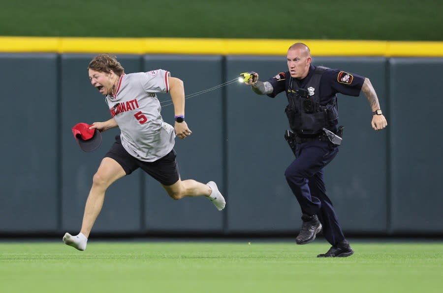 CINCINNATI, OHIO – JUNE 11: An unidentified fan is tased by a police officer as he runs on the field before the ninth inning of the Cincinnati Reds against Cleveland Guardians at Great American Ball Park on June 11, 2024 in Cincinnati, Ohio. (Photo by Andy Lyons/Getty Images)