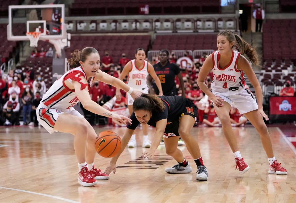Ohio State Buckeyes guard Taylor Mikesell (24) steals the ball from Maryland Terrapins guard Katie Benzan (11) witl defensive help from guard Jacy Sheldon (4) during the fourth quarter of the NCAA women's basketball game at Value City Arena in Columbus on Thursday, Jan. 20, 2022. Ohio State won 95-89.