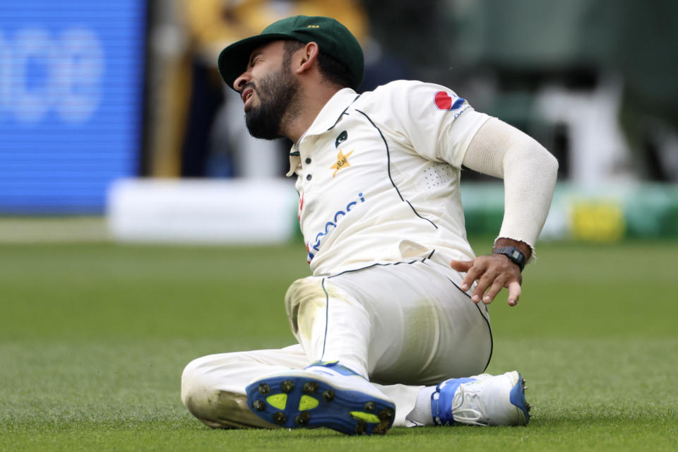 Pakistan's Aamer Jamal grimaces as he appears to injure himself while fielding against Australia during their cricket test match in Melbourne, Tuesday, Dec. 26, 2023. (AP Photo/Asanka Brendon Ratnayake)
