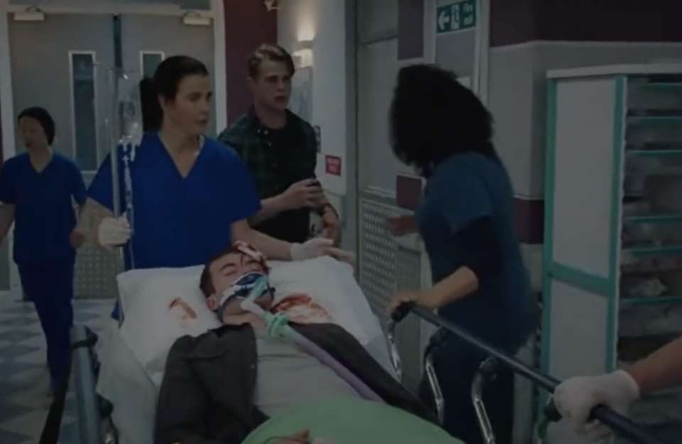 a group of people standing around a baby in a hospital bed