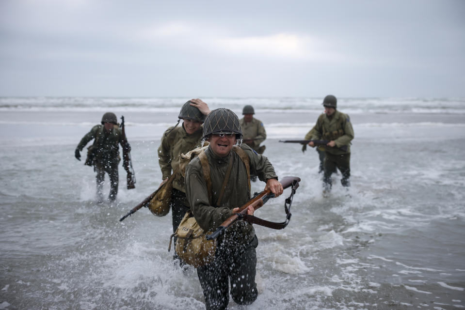 World War II reenactors walk on the beach of Omaha Beach in Saint-Laurent-sur-Mer, Normandy, France, Tuesday, June 6, 2023. The D-Day invasion that helped change the course of World War II was unprecedented in scale and audacity. Nearly 160,000 Allied troops landed on the shores of Normandy at dawn on June 6, 1944. (AP Photo/Thomas Padilla)