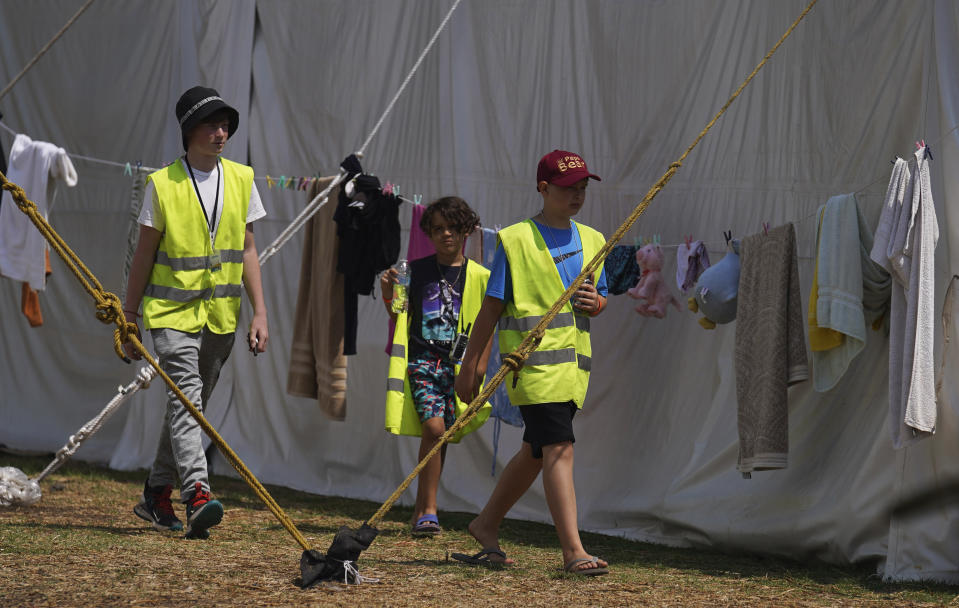 Ukrainian refugee children walk through a camp in Parque Utopia, in the Iztapalapa borough of Mexico City, Tuesday, May 24, 2022. Mexico City will close the camp that has hosted hundreds of Ukrainian refugees for the past month. Now that a U.S. program vetting refugees and then allowing them to fly to the U.S. is operational, authorities say the camp is no longer needed. (AP Photo/Marco Ugarte)