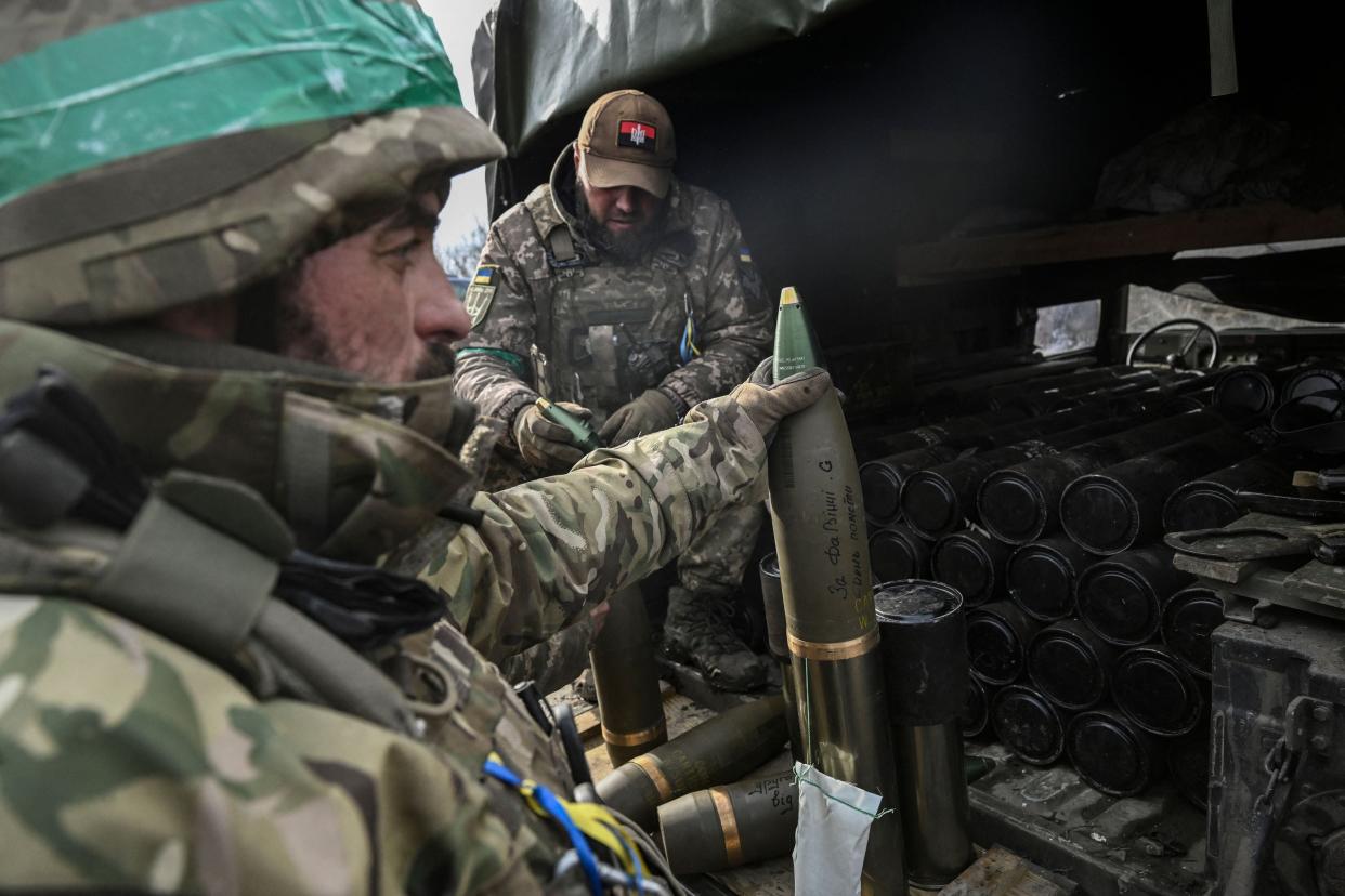 Ukrainian serviceman holds a shell of a 105mm howitzer near the city of Bakhmut as they look at their ammunition stock in the raging battle for the mining city (AFP via Getty Images)