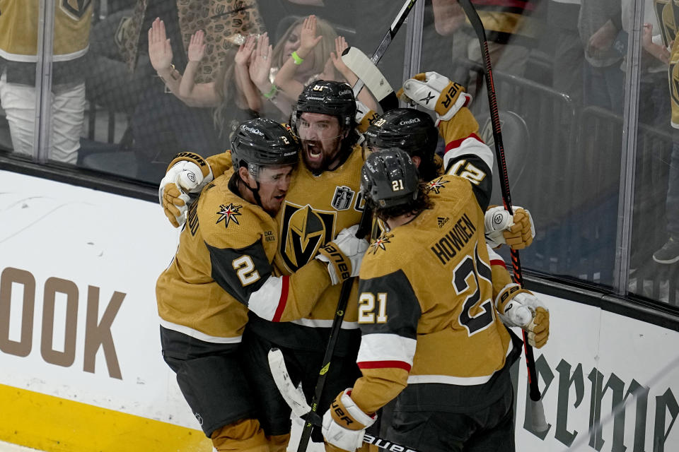 Vegas Golden Knights right wing Mark Stone, left, celebrates his goal against the Florida Panthers with Brett Howden (21), defenseman Zach Whitecloud (2) and center Chandler Stephenson during the third period of Game 1 of the NHL hockey Stanley Cup Finals, Saturday, June 3, 2023, in Las Vegas. (AP Photo/Abbie Parr)