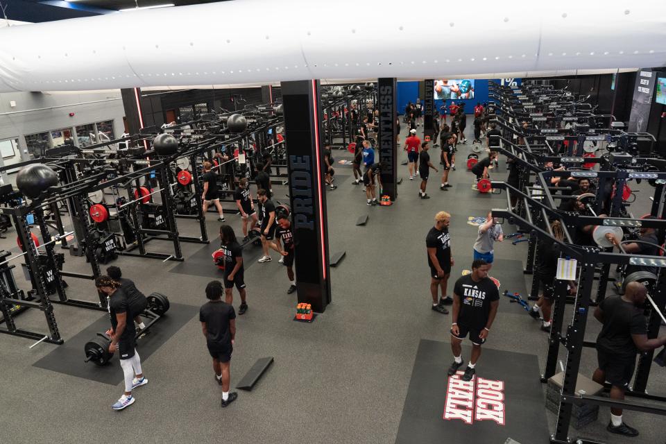 A view from above the new weight room inside the University of Kansas Anderson Family Football Complex shows players using the new equipment Tuesday.