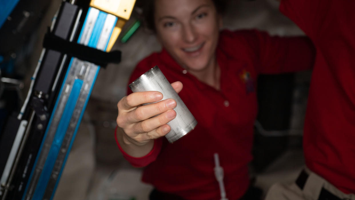  A NASA astronaut holds a water filter in a recycling system on the international space station 