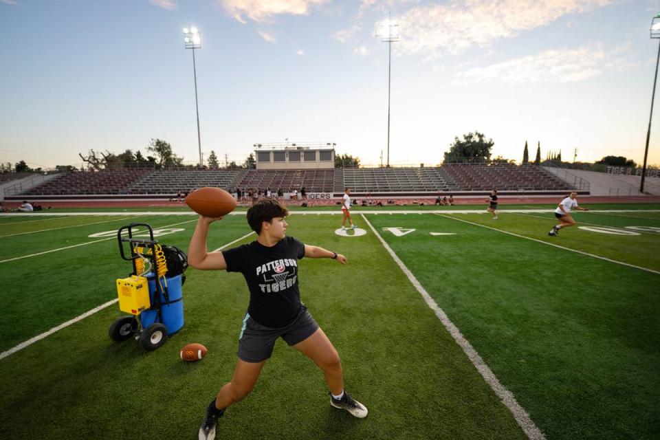 Gillian Emehiser makes a pass during a passing drill at practice for Patterson’s new flag football team at Patterson High School in Patterson, Calif., Tuesday, August 1, 2023.