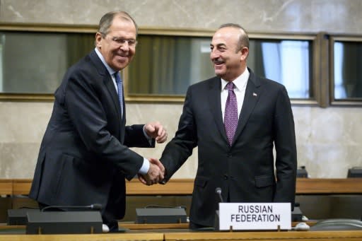 Russian foreign minister Sergei Lavrov shakes hands with his Turkish counterpart Mevlut Cavusoglu in Geneva on Tuesday