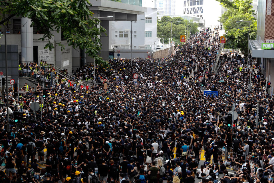 Protesters gather outside the police headquarters in Hong Kong Friday, June 21, 2019. Several hundred mainly student protesters gathered outside Hong Kong government offices Friday morning, with some blocking traffic on a major thoroughfare, after a deadline passed for meeting their demands related to controversial extradition legislation that many see as eroding the territory's judicial independence. (AP Photo/Vincent Yu)