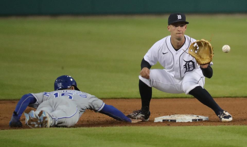 Tigers second baseman Zack Short holds Royals right fielder Whit Merrifield at second base during the Tigers' 6-2 loss to the Royals on Friday, April 23, 2021, at Comerica Park.