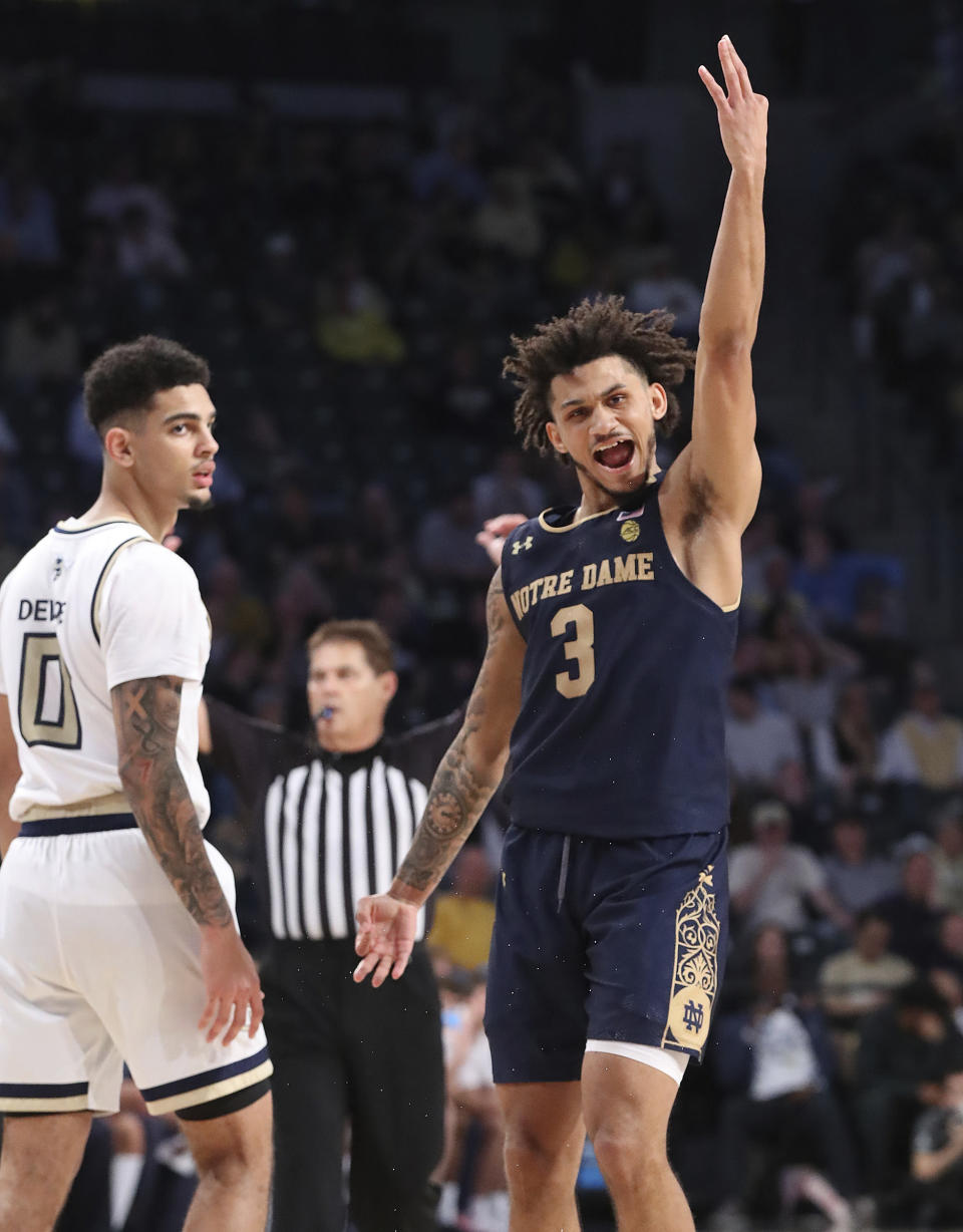 Notre Dame guard Prentiss Hubb reacts to hitting a 3-pointer, next to Georgia Tech guard Michael Devoe in the final minutes of Notre Dame's win in an NCAA college basketball game Wednesday, Jan. 15, 2020, in Atlanta. (Curtis Compton/Atlanta Journal-Constitution via AP)