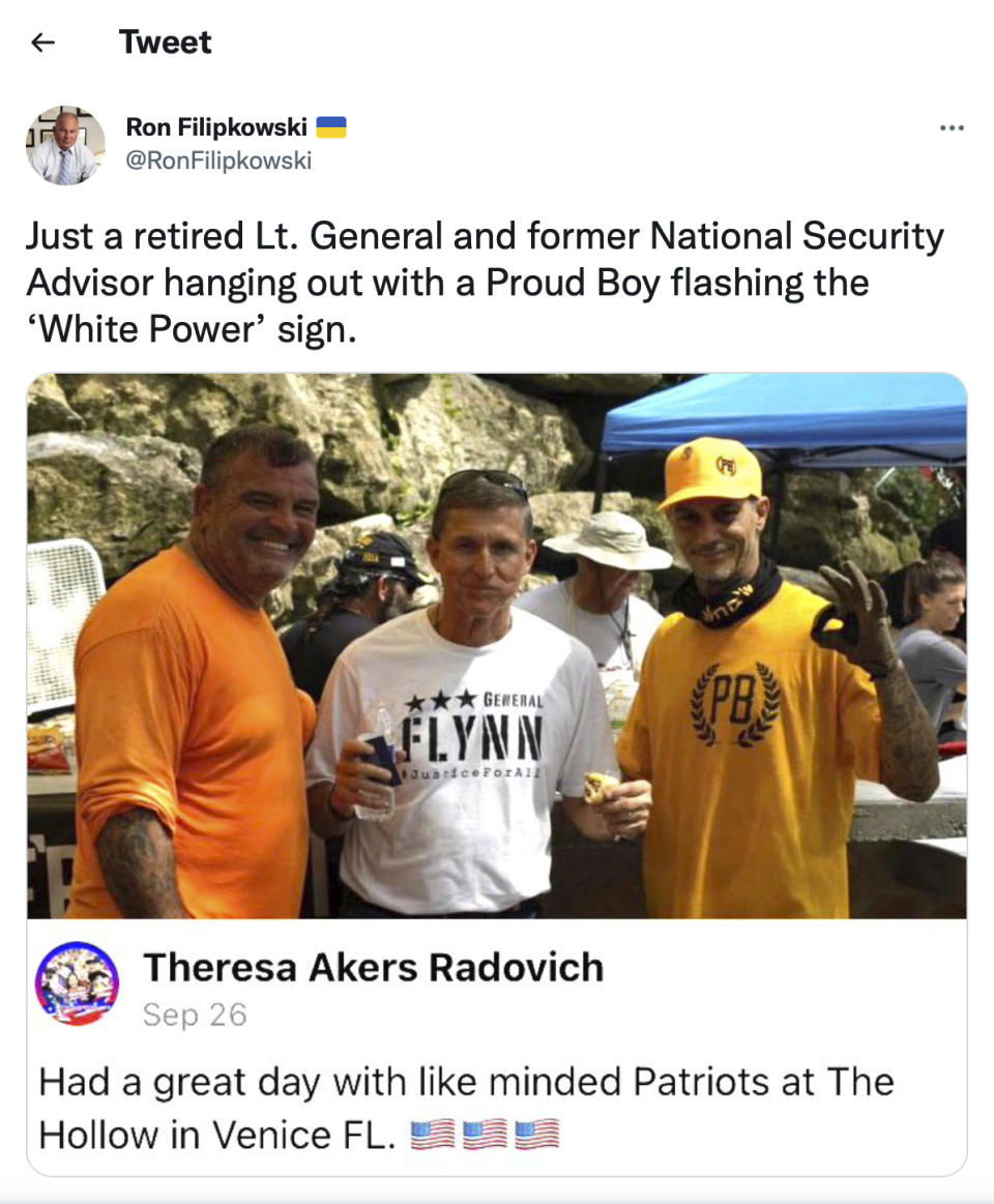 This image from the Twitter account of Sarasota, Fla., lawyer Ron Filipkowski, who tracks far-right figures online, shows a photo originally posted on Facebook on Sept. 26, 2021, of Michael Flynn, center, eating a hot dog with Victor Mellor Sr., owner of The Hollow, left, and an unidentified man in a Proud Boys shirt, at Mellor's venue in Venice, Fla. (AP Photo)