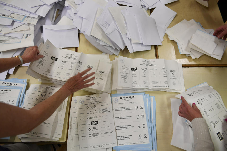 Ballots are being counted after polling stations closed for the general election in Budapest, Hungary, Sunday, April 3, 2022. Hungarian voters in the Central European country faced a choice: take a chance on a diverse, Western-looking coalition of opposition parties, or grant nationalist Prime Minister Viktor Orban a fourth consecutive term. (AP Photo/Anna Szilagyi)