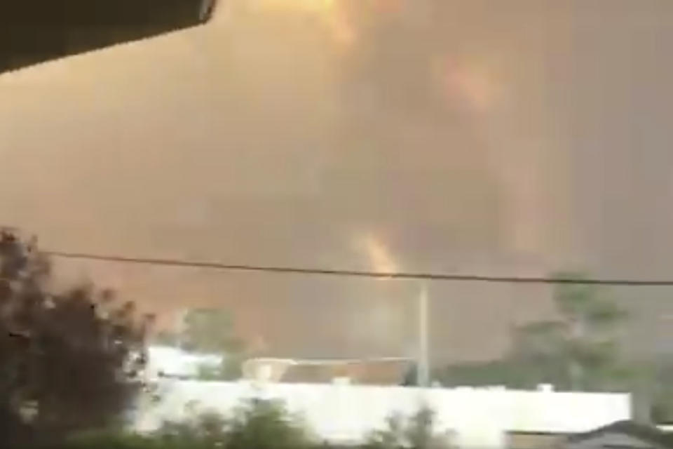 In this Tuesday, Dec. 31, 2019, image from video,smoke and fires are seen from Batehaven, near Batemans Bay, New South Wales, Australia. Thousands of tourists fled Australia's wildfire-ravaged eastern coast Thursday, Jan. 2, 2020, ahead of worsening conditions as the military started to evacuate people trapped on the shore further south. (Josh Aldwell via AP)