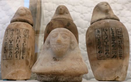 Artefacts discovered at an ancient burial site are seen inside a glass casing, on display near Egypt's Saqqara necropolis, in Giza Egypt July 14, 2018. REUTERS/Mohamed Abd El Ghany