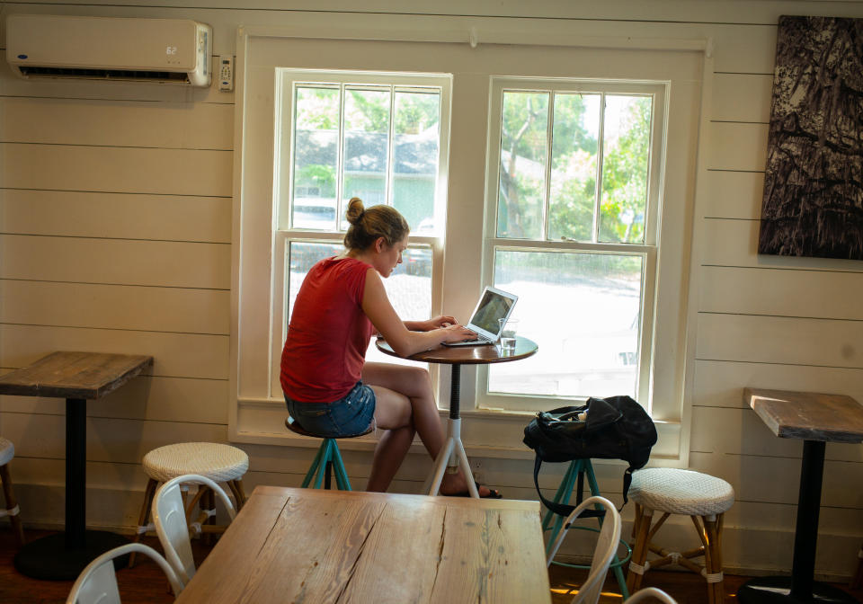 A woman works on her laptop computer at a coffee shop in Mount Pleasant, South Carolina on April 24, 2019.  (Photo by Robert Nickelsberg/Getty Images)