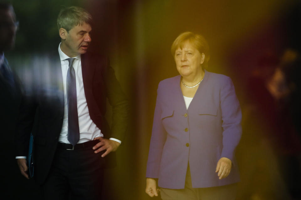 FILE - In this June 13, 2019, file photo, German Chancellor Angela Merkel, right, talks to then foreign policy advisor Jan Hecker, left, as she arrives to welcome the Prime Minister of North Macedonia Zoran Zaev for a meeting at the chancellery in Berlin, Germany. Jan Hecker, Germany's new ambassador to China, a former adviser to Merkel, has died, the German Foreign Ministry said Monday, Sept, 6, 2021. (AP Photo/Markus Schreiber, File)