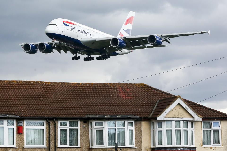 An A380 British Airways plane is seen over the houses in West London as it approaches to land at London Heathrow airport