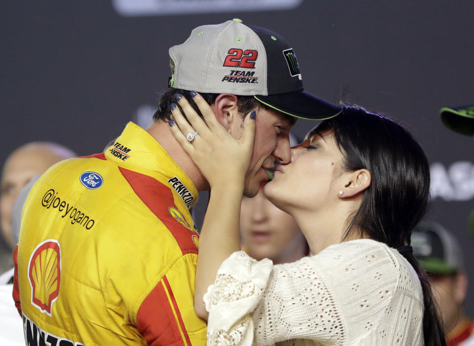 Joey Logano kisses his wife, Brittany Baca, after winning the NASCAR Cup Series championship auto race at Homestead-Miami Speedway, Sunday, Nov. 18, 2018, in Homestead, Fla. (AP Photo/Lynne Sladky)