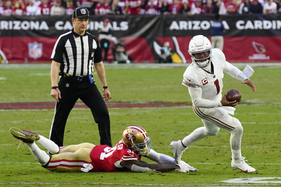 Arizona Cardinals quarterback Kyler Murray (1) scrambles away from San Francisco 49ers safety Tashaun Gipson Sr. (31) during the second half of an NFL football game Sunday, Dec. 17, 2023, in Glendale, Ariz. (AP Photo/Ross D. Franklin)