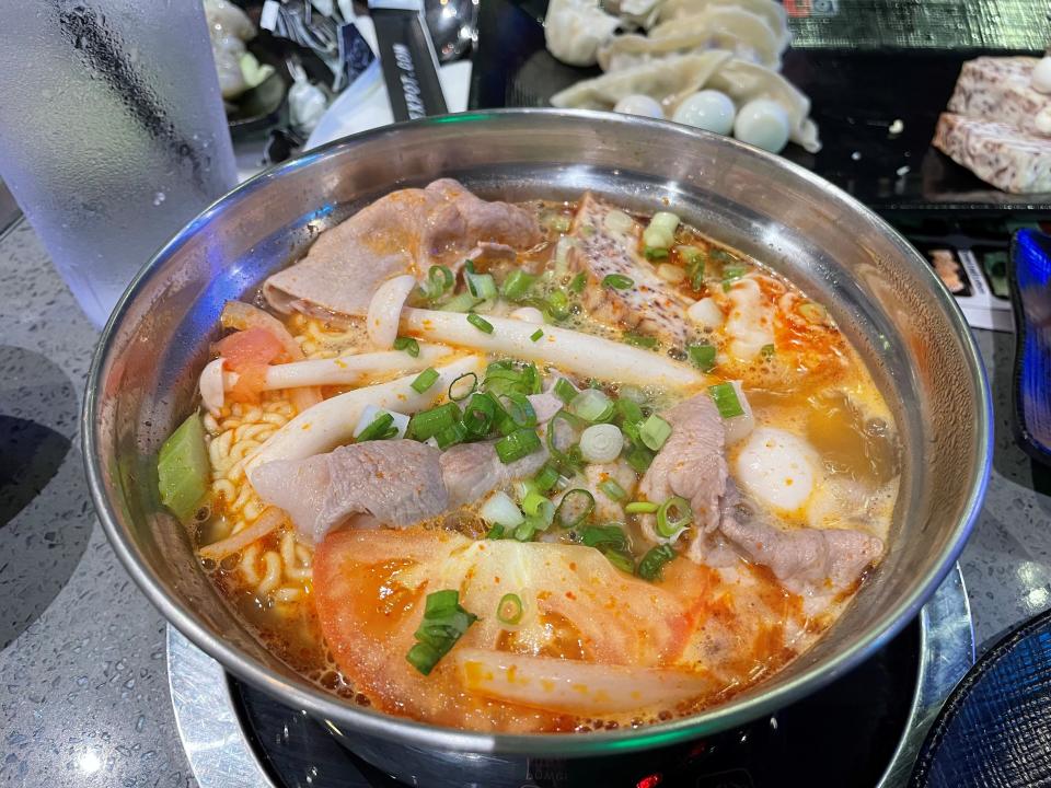 Thai tom yum hot pot with pork, ramen, quail eggs, beech mushrooms and tomatoes at KPot Korean BBQ & Hot Pot in Toms River.
